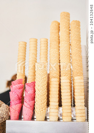blank ice cream wafers. Waffle cones in an ice-cream shop, Italy. A variety of sugar-free vegan ice cream with natural ingredients on display at the Italian gelateria. Natural fresh ice cream. blank ice cream wafers. Waffle cones in an ice-cream shop, Italy. A variety of sugar-free vegan ice cream with natural ingredients on display at the Italian gelateria. Natural fresh ice cream. 104132648