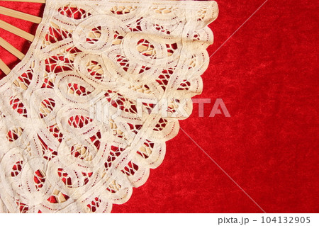 Vintage Lace Hand Fan On Red Velvet Background 104132905