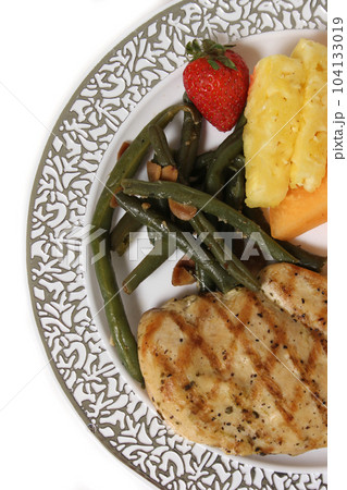 Chicken and Vegetable Dinner With Fruit at Wedding Isolated on White Background 104133019