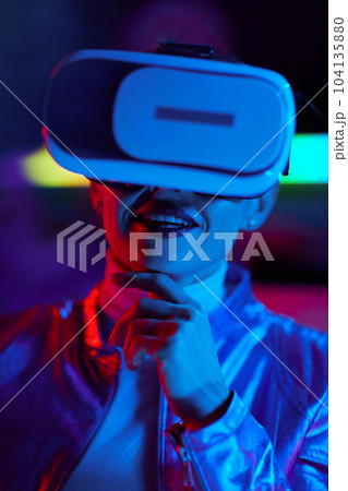 happy business woman in virtual reality goggles on dark 104135880