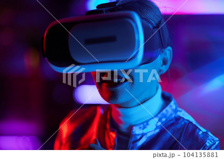 happy stylish business woman in vr headset on dark background happy stylish business woman in vr headset on dark background 104135881