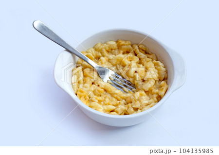 Mashed bananas in bowl on white background. Mashed bananas in bowl on white background. 104135985