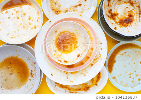 Dirty dishes on yellow background. Top view Dirty dishes on yellow background. Top view 104136837