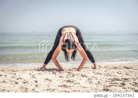 Fitness Girl working out on the beach Fitness Girl working out on the beach 104137561