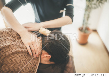 顔周りをマッサージされる若い女性 顔周りをマッサージされる若い女性 104140418