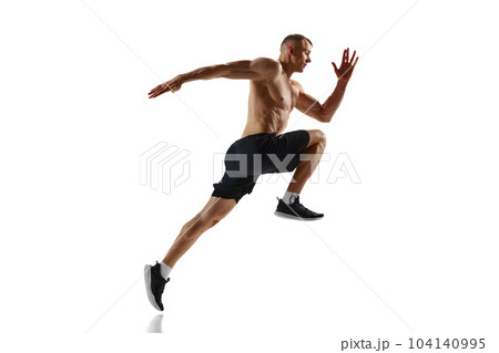 Endurance. Dynamic image of professional sportsman, shirtless muscular man in motion, running, training against white studio background Endurance. Dynamic image of professional sportsman, shirtless muscular man in motion, running, training against white studio background 104140995