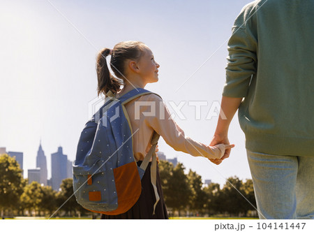 Parent and pupil going to school 104141447