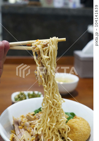 Mie Ayam or Chicken Noodle served in a bowl with meatballs in a restaurant in Semarang, Indonesia. 104141639