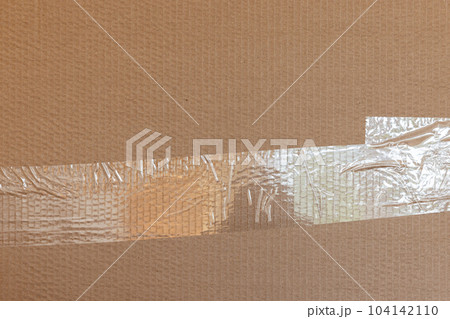 Pressure-sensitive tape is on a cardboard, front view 104142110