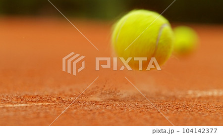 Freeze motion of flying tennis ball in court. 104142377