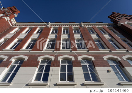Bottom view of the front wall of the historic red brick building. Bottom view of the front wall of the historic red brick building. 104142460