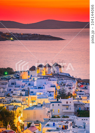 Mykonos, Greece. Sunset over Aegean Sea and the famous windmill from above, Cyclades. 104144066