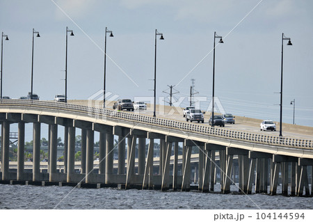 Barron Collier Bridge and Gilchrist Bridge in Florida with moving traffic. Transportation infrastructure in Charlotte County connecting Punta Gorda and Port Charlotte over Peace River 104144594