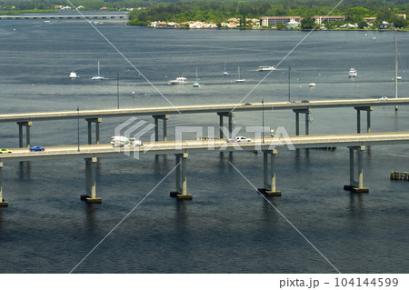 Barron Collier Bridge and Gilchrist Bridge in Florida with moving traffic. Transportation infrastructure in Charlotte County connecting Punta Gorda and Port Charlotte over Peace River 104144599