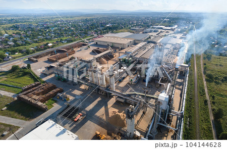 Aerial view of wood processing factory with stacks of lumber at plant manufacturing yard. Aerial view of wood processing factory with stacks of lumber at plant manufacturing yard. 104144628
