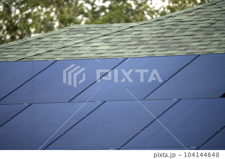 Aerial view of typical american building roof with blue solar photovoltaic panels for producing clean ecological electric energy. Investing in renewable electricity for retirement income concept 104144648