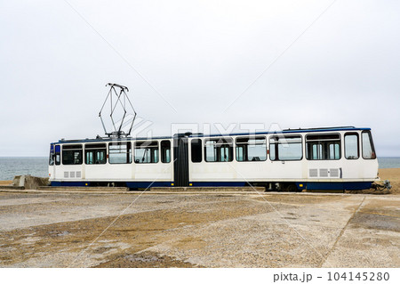 A used white electric tram car on the shore of the Baltic Sea for setting up a cafe, tram as a cafe 104145280