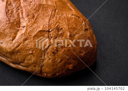 Delicious fresh crispy loaf of white bread with grains and seeds 104145702