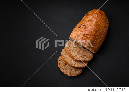 Delicious fresh crispy loaf of white bread with grains and seeds Delicious fresh crispy loaf of white bread with grains and seeds 104145712