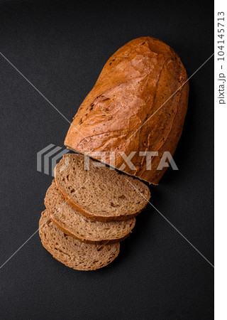 Delicious fresh crispy loaf of white bread with grains and seeds Delicious fresh crispy loaf of white bread with grains and seeds 104145713