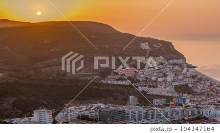 Aerial sunrise view of the coastline of the village of Sesimbra timelapse. Portugal Aerial sunrise view of the coastline of the village of Sesimbra timelapse. Portugal 104147164