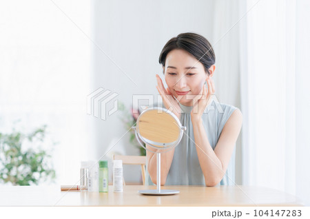 リビングでスキンケアをするミドルの女性 104147283