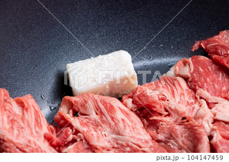 牛肉(ウデ薄切り)をフライパンで焼く調理シーンの、牛脂を中心としたアップ。 104147459
