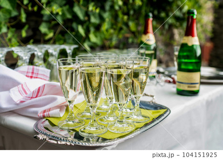 sparkling wine in glasses in restaurant or on a party wedding dinner setting 104151925