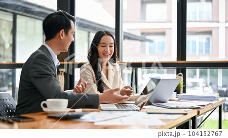 An Asian businessman is sharing his ideas and discussing work with a female colleague An Asian businessman is sharing his ideas and discussing work with a female colleague 104152767