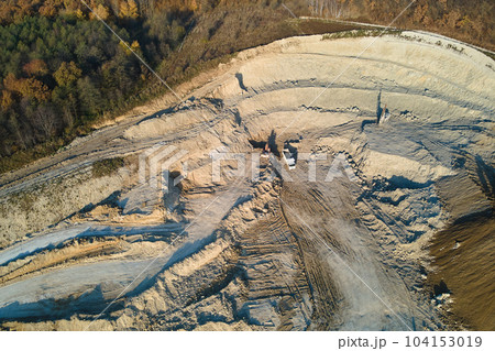 Aerial view of open pit mine of sandstone materials for construction industry with excavators and dump trucks. Heavy equipment in mining and production of useful minerals concept 104153019