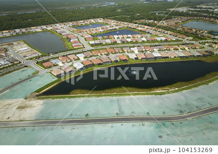 Aerial view of construction site with new tightly packed homes in Florida closed living clubs. Family houses as example of real estate development in american suburbs 104153269