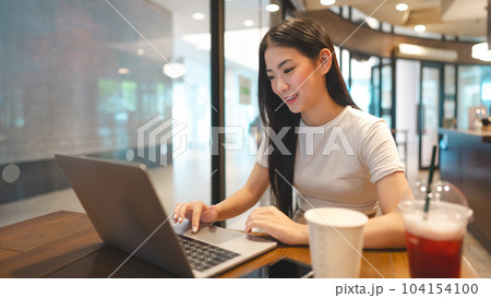 Business freelance asian woman using laptop computer at cafe urban lifestyle 104154100