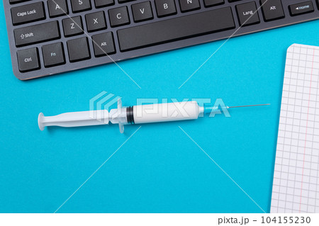 Vaccination or Revaccination Concept - A Medical Syringe on Blue Table 104155230