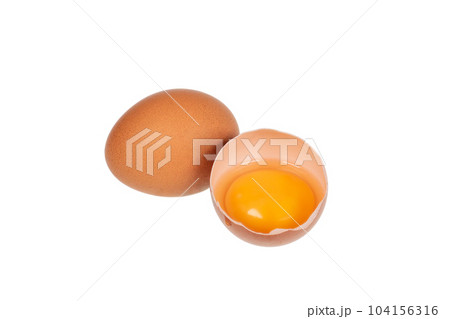 Yolk in an eggshell on a white background. Yolk in an eggshell on a white background. 104156316