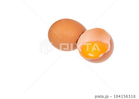 Yolk in an eggshell on a white background. Yolk in an eggshell on a white background. 104156318
