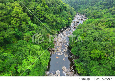 Beautiful touristic scenery of Cheonjeyeon Waterfall, a famous tourist attraction in Jeju Island. 104157597
