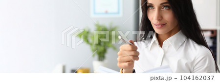 Portrait of a pensive beautiful businesswoman with pen and diary 104162037