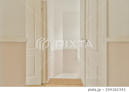 the inside of a room with white walls and wood flooring in an empty apartment, taken from the front door 104162341