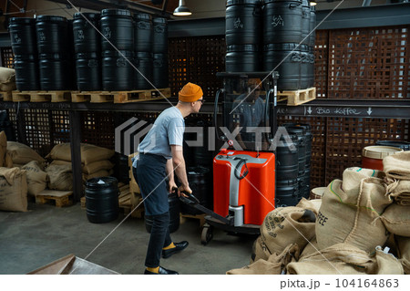 Hipster man roasting factory worker preparing coffee beans for coffee brewing. Hipster man roasting factory worker preparing coffee beans for coffee brewing. 104164863