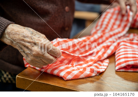 Elder hands, folding napkins 104165170