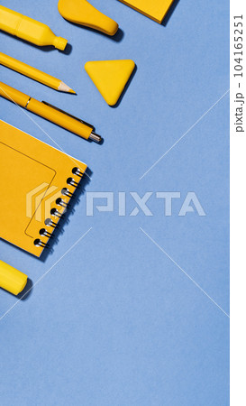 Assorted office and school yellow stationery on lilac blue. copy space for back to school or education craft office work concept. Bright Yellow rocket. Achievement and success. Top view Assorted office and school yellow stationery on lilac blue. copy space for back to school or education craft office work concept. Bright Yellow rocket. Achievement and success. Top view 104165251