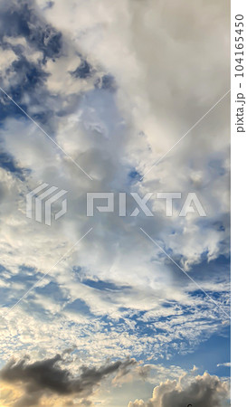 Blue sky with clouds, flying birds and a rainbow. Summer nature. Clouds at sunset. Blue sky with clouds, flying birds and a rainbow. Summer nature. Clouds at sunset. 104165450