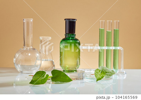 Bottle without label standing on round podium with laboratory concept. Cosmetic laboratory research and development with Fish mint (Houttuynia cordata) extract 104165569