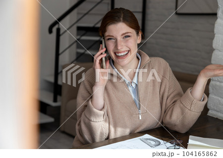 Smiling young woman talking on the phone and feeling excited 104165862