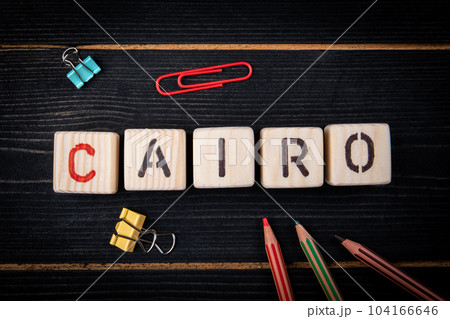 CAIRO. City name from blocks on a dark wood texture background 104166646