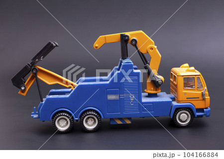 Toy tow truck on black background Toy tow truck on black background 104166884