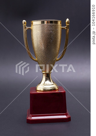 Golden trophy cup on black background. Golden trophy cup on black background. 104166910