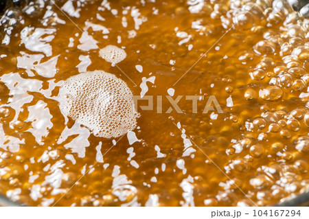 だし汁をフライパンに入れて煮立たせる調理シーン。 104167294