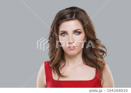 Portrait of beautiful brunette. Nice woman with makeup looking at camera on white background 104168010