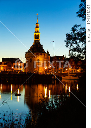 Night view of illuminated Hoofdtoren tower in Hoorn city port on lake Markermeer 104168193